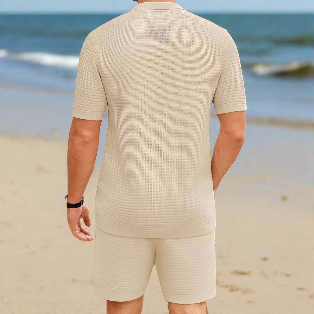 Man wearing White Sand Set standing on a sunny beach shore